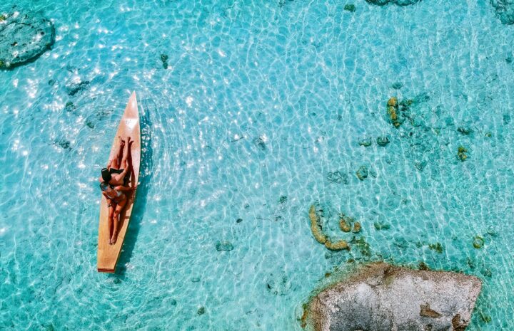 aerial photo of person riding boat during daytime