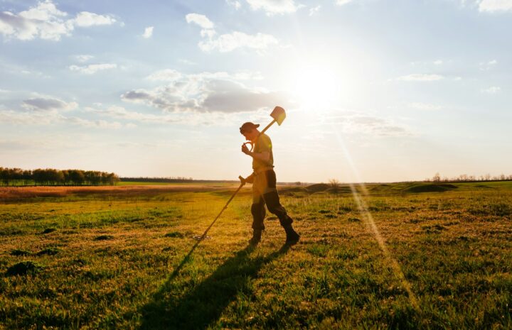 a man holding a ball and walking in a field